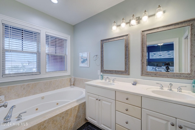 bathroom featuring vanity and tiled tub