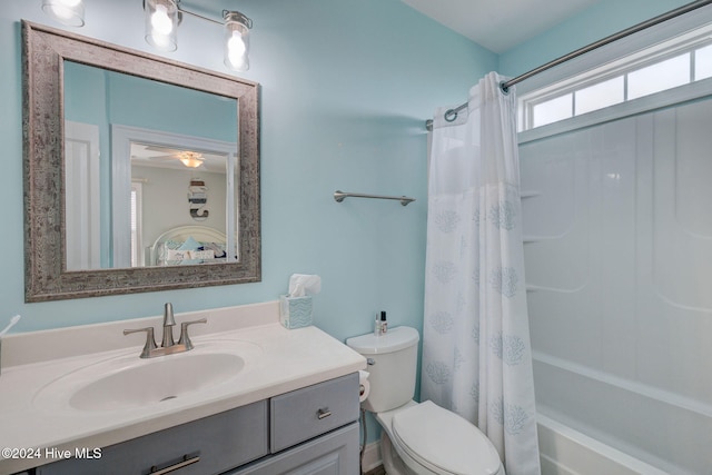 full bathroom featuring shower / bath combo with shower curtain, vanity, and toilet