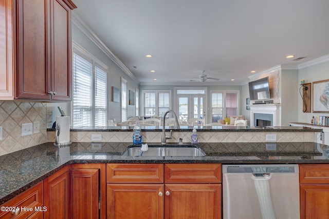 kitchen featuring dark stone counters, sink, dishwasher, and ornamental molding