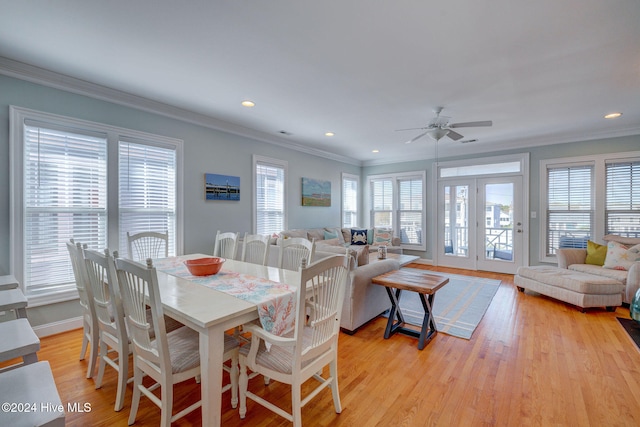 dining space with ceiling fan, light hardwood / wood-style floors, and crown molding