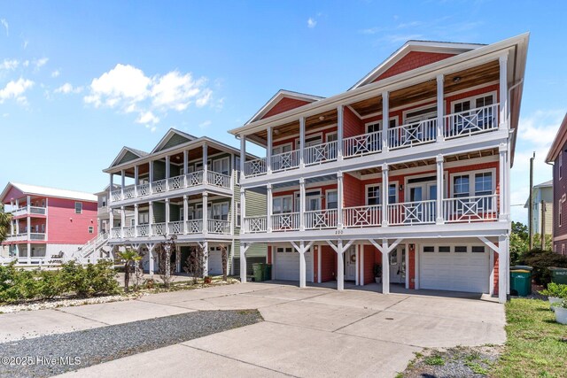 230 Third Ave Unit A, Kure Beach, NC 28449 - view of front of house with an attached garage, driveway, and a balcony
