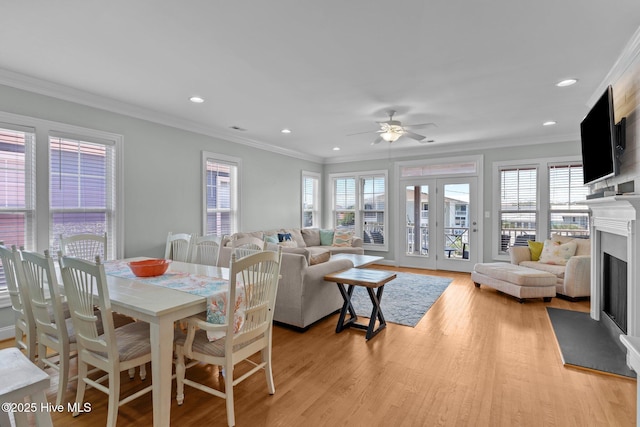 230 Third Ave Unit A, Kure Beach, NC 28449 - dining space with a fireplace, ornamental molding, healthy amount of natural light, light wood-type flooring, and recessed lighting