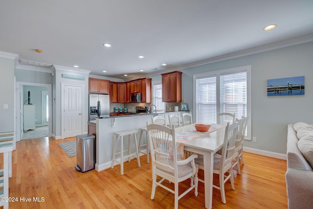 230 Third Ave Unit A, Kure Beach, NC 28449 - dining room featuring crown molding, light wood-type flooring, baseboards, and recessed lighting