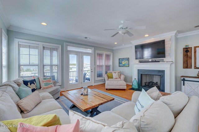 230 Third Ave Unit A, Kure Beach, NC 28449 - living area featuring healthy amount of natural light, ceiling fan, a large fireplace, recessed lighting, and ornamental molding