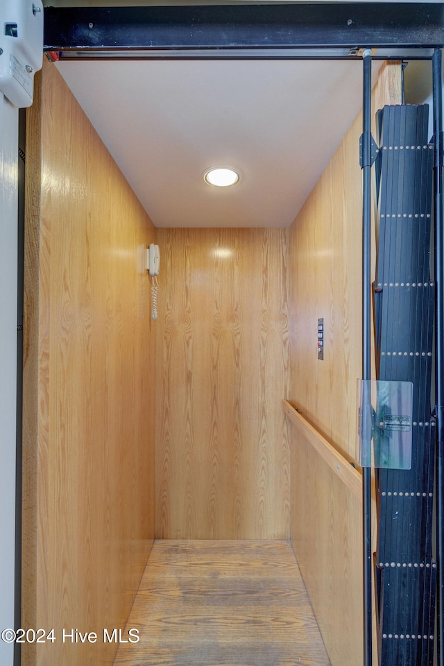 interior details with elevator and wood walls