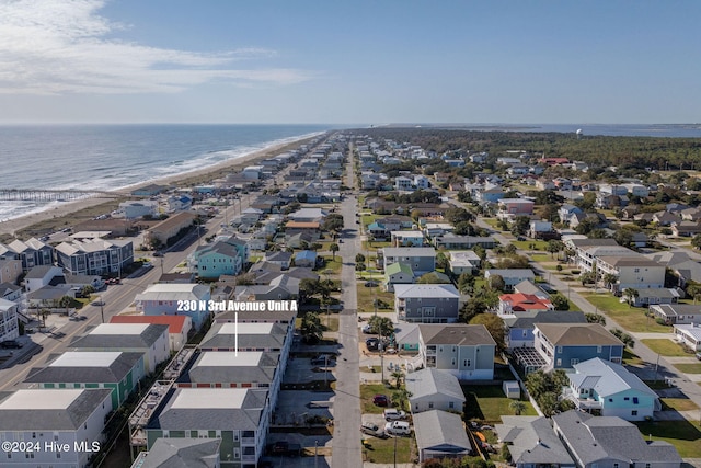 drone / aerial view with a beach view and a water view