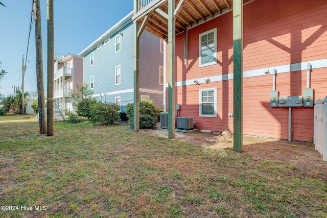 view of home's exterior featuring central AC and a yard