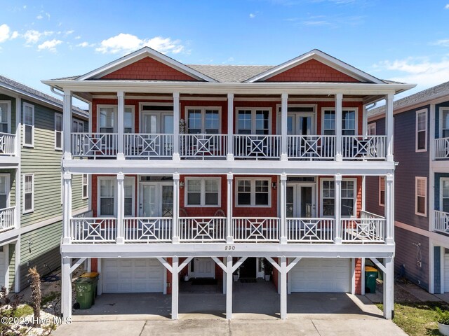 230 Third Ave Unit A, Kure Beach, NC 28449 - view of front of home with an attached garage and concrete driveway