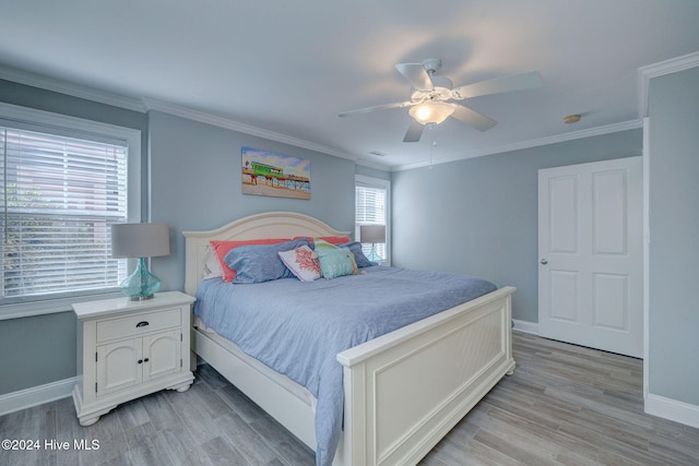 bedroom with ornamental molding, multiple windows, ceiling fan, and light hardwood / wood-style flooring