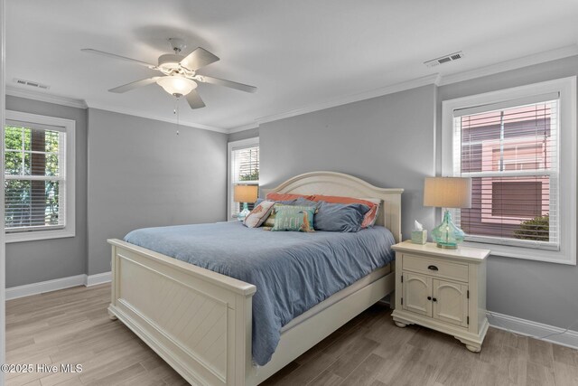 230 Third Ave Unit A, Kure Beach, NC 28449 - bedroom featuring baseboards, light wood finished floors, ceiling fan, and ornamental molding