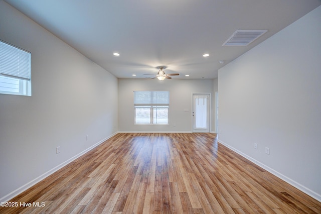 empty room featuring ceiling fan and light wood-type flooring