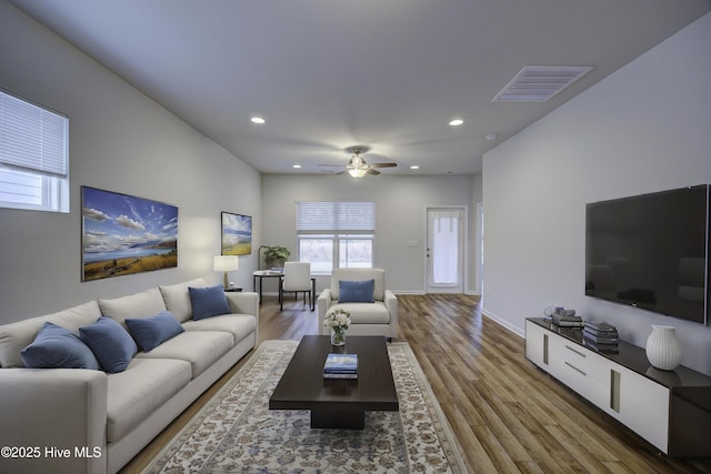 living room with ceiling fan and wood-type flooring