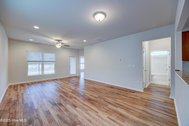 unfurnished living room featuring ceiling fan and light hardwood / wood-style flooring