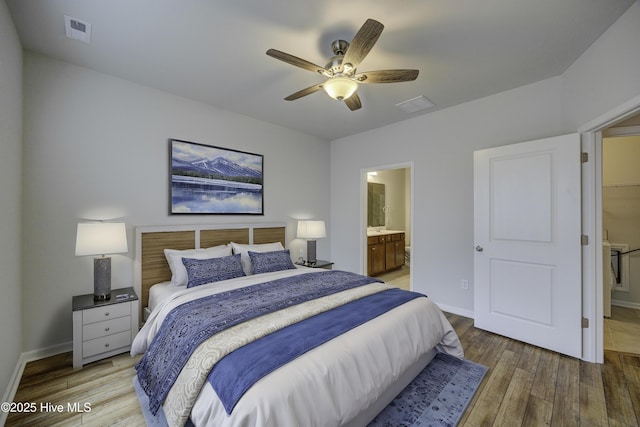 bedroom with hardwood / wood-style floors, ensuite bathroom, and ceiling fan