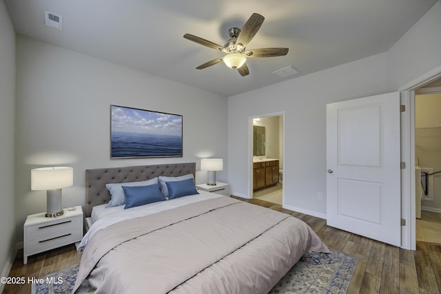 bedroom featuring ensuite bathroom, ceiling fan, and dark wood-type flooring