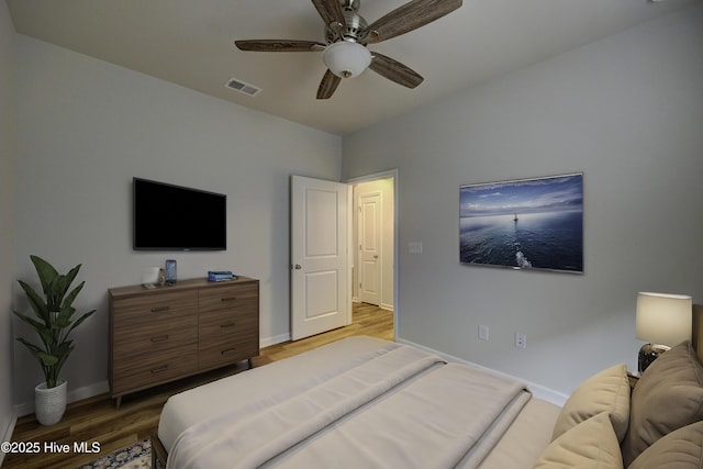 bedroom with wood-type flooring and ceiling fan