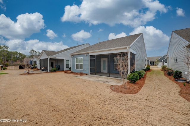 back of property with a patio area and a sunroom