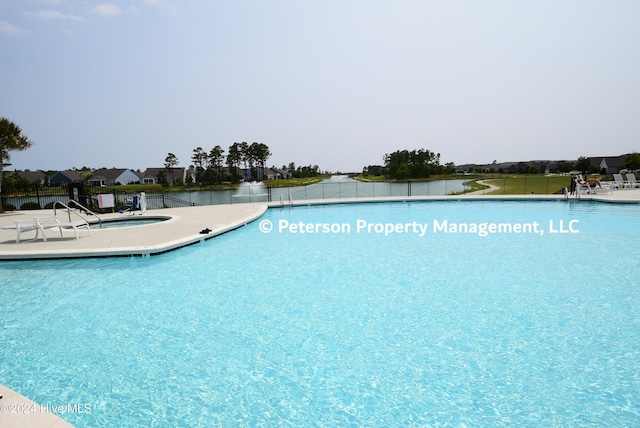 view of swimming pool with a water view