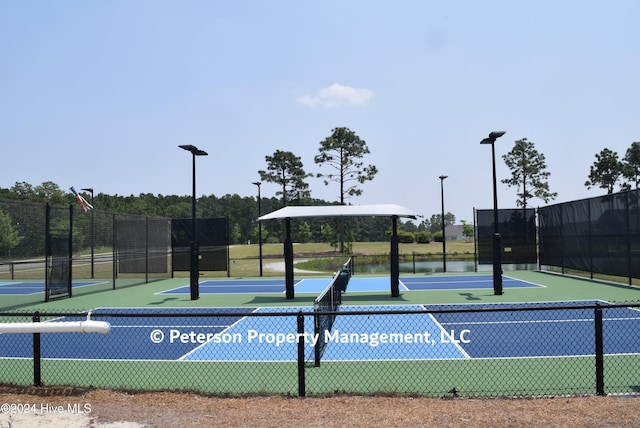 view of sport court featuring a water view