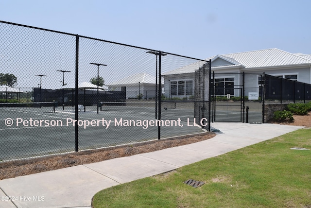 view of sport court featuring tennis court