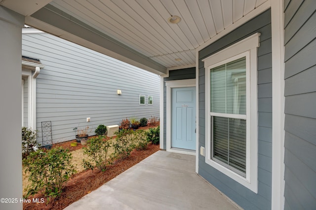 view of exterior entry featuring a porch