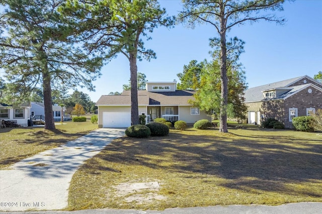 view of front of house with a front yard and a garage