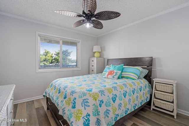 bedroom with a textured ceiling, dark hardwood / wood-style flooring, ceiling fan, and crown molding