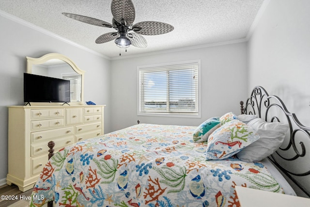 bedroom with wood-type flooring, ceiling fan, a textured ceiling, and ornamental molding