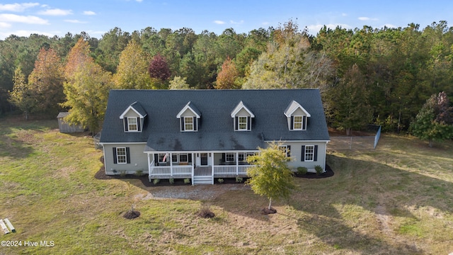 new england style home with covered porch and a front yard