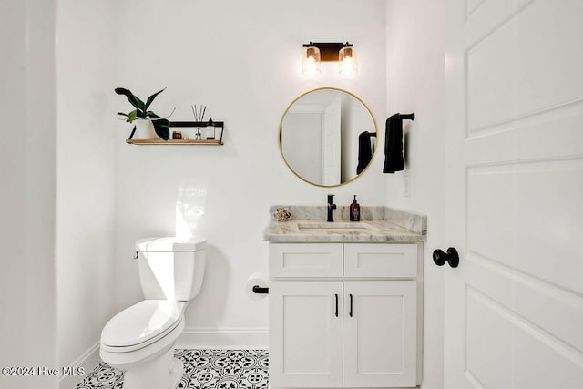 bathroom featuring tile patterned floors, vanity, and toilet