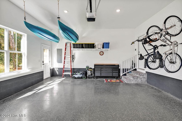 garage with electric panel and a garage door opener