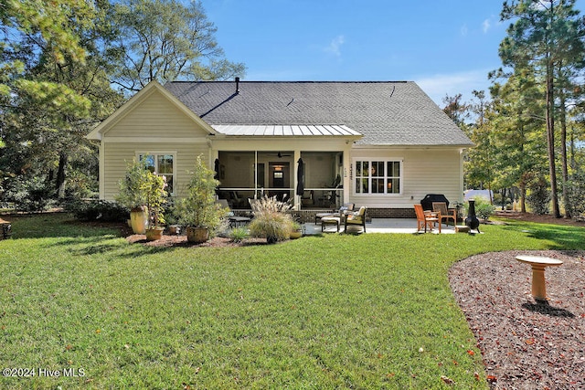 rear view of house with a yard and a patio