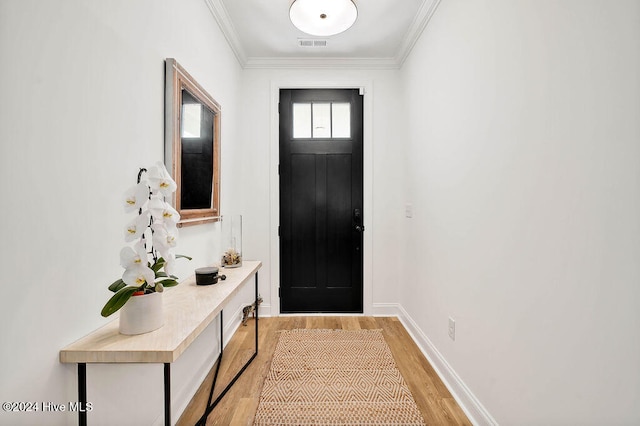 doorway with crown molding and light wood-type flooring