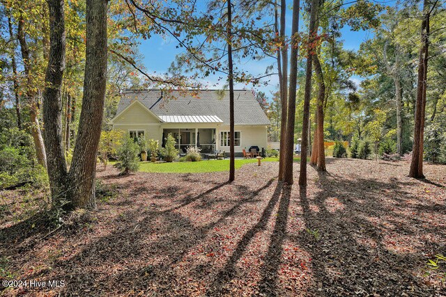 rear view of house featuring covered porch