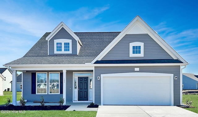 view of front of house featuring a garage and a front lawn