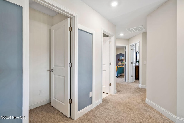 hall featuring light colored carpet