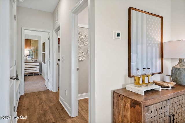 hallway with hardwood / wood-style flooring