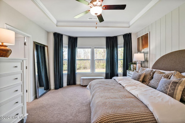 bedroom with ceiling fan, carpet flooring, and a raised ceiling