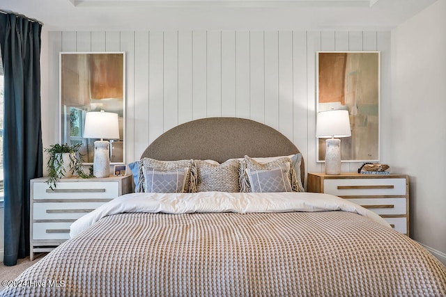 carpeted bedroom with wood walls