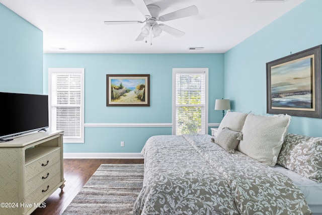 bedroom with ceiling fan and dark hardwood / wood-style floors