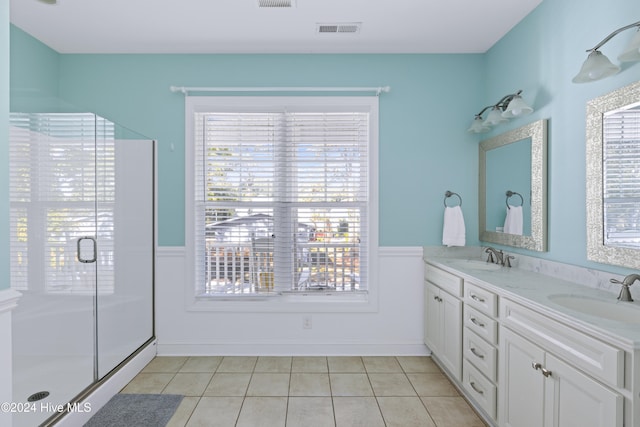 bathroom with tile patterned floors, a shower with door, and a healthy amount of sunlight