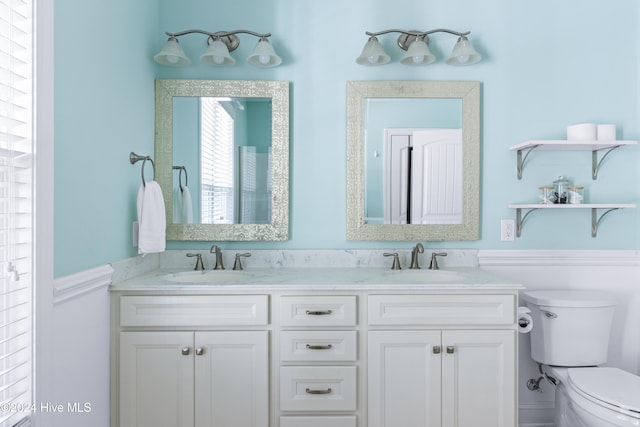 bathroom featuring toilet and vanity