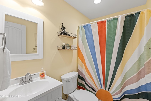 bathroom featuring toilet and vanity