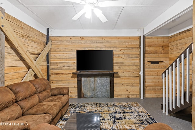 living room with wooden walls and ceiling fan