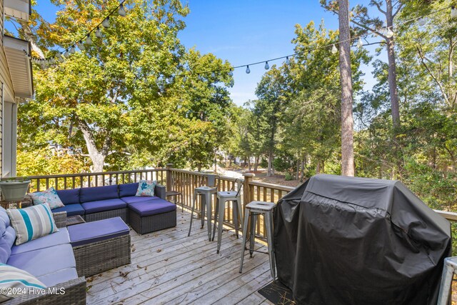 wooden deck featuring grilling area and an outdoor hangout area