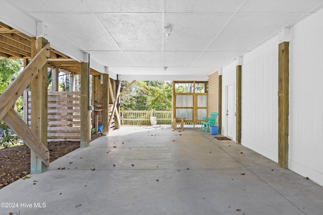 exterior space with concrete flooring and a drop ceiling