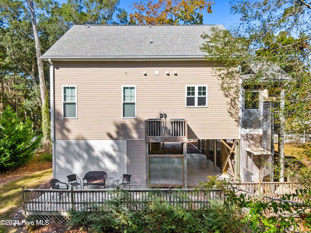 rear view of house with a patio area and a wooden deck