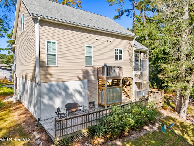 back of property with a wooden deck