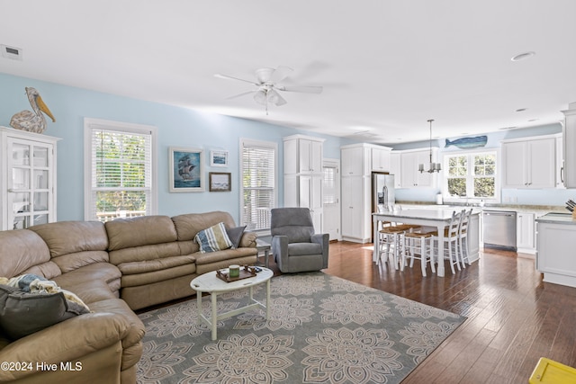 living room featuring dark hardwood / wood-style flooring and ceiling fan