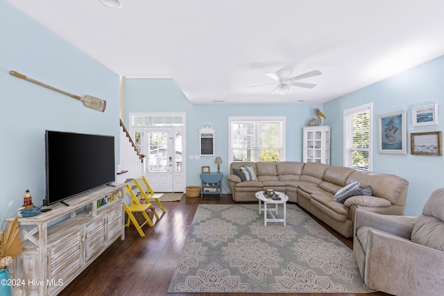 living room featuring ceiling fan and dark hardwood / wood-style flooring